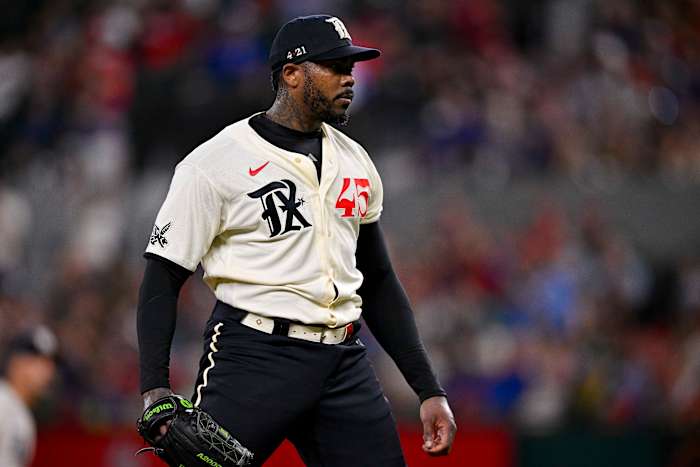 Jul 14, 2023; Arlington, Texas, USA; Texas Rangers relief pitcher Aroldis Chapman (45) reacts to striking out Cleveland Guardians center fielder Myles Straw (not pictured) to end the eighth inning at Globe Life Field. Mandatory Credit: Jerome Miron-USA TODAY Sports